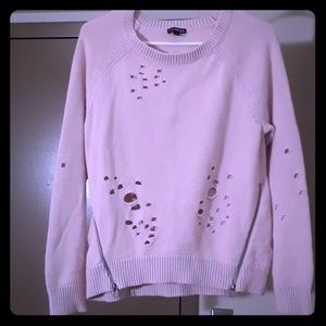Sweater styled with holes